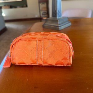 Coach orange monogrammed zippered pouch
